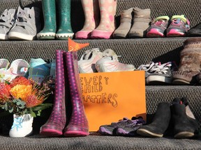 Approximately 200 childrens' shoes, boots and moccasins were placed on the steps of St. Columbkille's Cathedral in Pembroke Monday evening as a memorial to the 215 children whose remains were discovered on the grounds of a residential school in Kamloops, B.C.