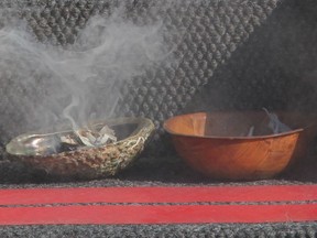 The smudge is made by lighting a match to dried plant medicines, so that it smolders.