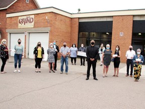 Marty Koch of Ottawa (black suit in front) recently donated $30,000 to six local organizations ($5,000 each) after winning $1.4 million on the CHEO 50/50 lottery and presented the cheques outside The Grind Pembroke. On hand for the presentation (from left) Heather Jobe and Kate Graham, Ontario SPCA Renfrew County Animal Care Centre; Adrienne Campbell, Bonnie Wells, Deacon Adrien Chaput and Jerry Novack, The Grind Pembroke; Leigh Costello and Roger Martin, PRH Foundation; Koch; Cheryl Summers, PRH Acute Mental Health; Donna Stokell and Melissa Siegel, Robbie Dean Family Counselling Centre; John Kilborn, St. Joseph's Food Bank and Laurie Alton, Petawawa Pantry Food Bank.