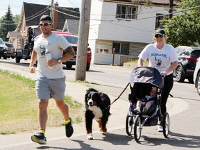 The Johnson family – Brad, Ginny and 14-month-old Isabella – makes its way into Pembroke's Riverside June 13 at the conclusion of the 155-kilometre Brad Runs for Krista fundraiser for the Elevate Youth Wellness Centre. The run raised in excess of $25,000.