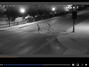 Owen Sound police released a short video Thursday hoping the public will help identify two individuals who appear to be vandalizing the city's newly painted rainbow-coloured Pride crosswalk downtown. A timestamp on the recording shows the video was taken early Sunday morning. Screenshot from supplied video.