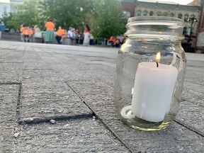 Organizers held a candlelight vigil Friday evening at Stratford's Market Square to remember the 215 children whose remains were found at the site of a former residential school in B.C.