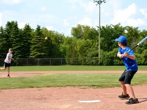 Quinn Smith throws a pitch to Will Pepper during a pickup baseball game with friends at one of the Oakdale Avenue ball diamonds in Stratford's west end.
(File photo/Galen Simmons)