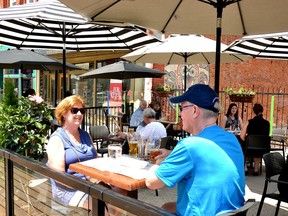 A couple in Stratford enjoy drinks on the patio at Mercer's Beer Hall. Outdoor dining tables will be allowed to seat six people when the province moves into Step 2 of its reopening plan Wednesday.
(Galen Simmons/Stratford Beacon Herald)