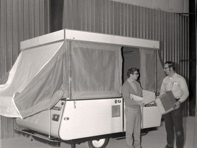 Robert Fiddler, general manager, and George Burgers, production manager, stand with the first model of a tent trailer manufactured in Listowel. 
Stratford-Perth Archives