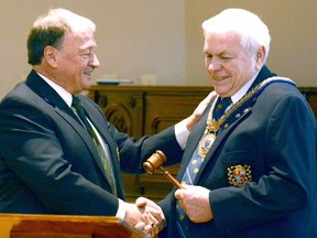 Bob Wilhelm, who served as Perth County warden in 2014 and 2015, presents the gavel of office to Mert Schneider in 2016.