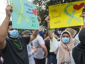 Sameer Mohammed and Huma Shareef hold signs outside the London mosque Tuesday in London during a vigil for the Afzaal-Salman family. Four members of the family were killed in what police alleged was a hate-motivated attack.

Mike Hensen/The London Free Press/Postmedia Network