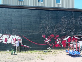 GRANDINETTI PROJECT: Local muralist Mark Grandinetti works on the Barzan Dentistry building mural site as part of the first phase of the Summer Moon Festival. BOB DAVIES/SAULT THIS WEEK
