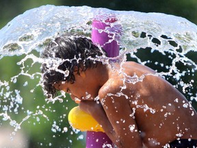 Demetrius St. John, 6, plays at the splash pad at Bellevue Park in July 2020. BRIAN KELLY