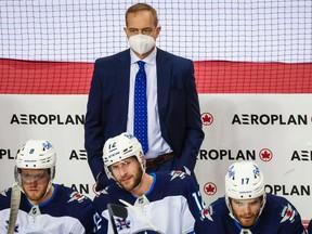 Winnipeg Jets head coach Paul Maurice stands behind his team's bench during a game against the Calgary Flames at Scotiabank Saddledome in May 2021. SERGEI BELSKI/USA TODAY