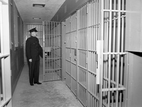 Douglas Janes shows the prison cells at Sarnia police headquarters in this 1955 photo from the Sarnia Observer Negative Collection at the Lambton County Archives. Heritage Sarnia-Lambton is hosting a digital panel discussion on historical crime in Lambton June 17. (Submitted)