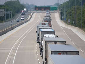 Transport trucks are shown backed up in the westbound lane of Highway 402 from the Indian Road overpass in Sarnia. Lambton OPP said the delay was caused by staffing issues on the U.S. of the Blue Water Bridge and that backups were expected through the day. Michigan's Department of Transportation reported on Twitter at 1 p.m. that westbound commercial vehicles could expect waits of longer than one hour at the bridge.
Paul Morden/The Observer