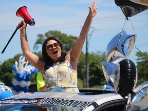 Lambton College graduate Ana Cordeiro celebrates during a graduation parade held Wednesday at the Sarnia campus. Nearly 700 of the more than 2,000 graduates in the college's class of 2021 took part in the convocation held outdoors because of pandemic restrictions.