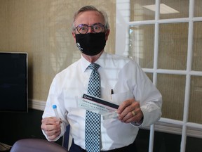 Allan Calvert, CEO of the Sarnia Lambton Chamber of Commerce, holds one of the rapid antigen COVID-19 tests being distributed for free by the Chamber as part of a provincewide initiative. The tests are available for small and medium-sized businesses with up to 150 employees.