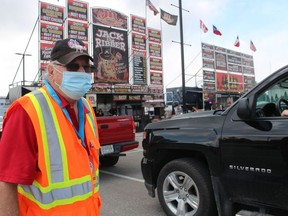 Jack Struck, chairperson of the Sarnia Kinsmen Ribfest, watches the lineup Sunday at this year's event held in a parking lot at Lambton College.