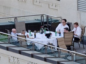 Premier Jason Kenney and some cabinet ministers are pictured on a patio in the Federal Building in Edmonton taken on June 1, 2021. From the top right is Environment & Parks Minister Jason Nixon, Minister of Environment & Parks, Health Minister Tyler Shandro, Kenney, Finance Minister Travis Toews and an unidentifiable man.