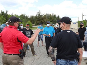 Const. Kevin Santi, left, of the Greater Sudbury Police, visits with members of United Steelworkers Local 6500 picketing at the entrance to Vale's Creighton Mine on Tuesday. Local 6500 members went on strike Tuesday after rejecting a tentative deal.
