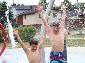 Julien Gaudette, 7, left, and his brother, Colton, 11, cool off at the splash pad at the DJ Hancock Memorial Park in Sudbury, Ont. on Thursday June 3, 2021. John Lappa/Sudbury Star/Postmedia Network