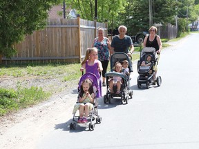 Abagail Buchanan, 8, front, leads a walk with Elli, Leo Thibeault, Audrey and Jack, Shannon Thibeault, Reggie Thibeault and Lincoln in Sudbury, Ont. on Thursday June 3, 2021. John Lappa/Sudbury Star/Postmedia Network