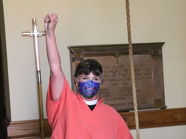 Rev. Elizabeth Green, of the Church of the Epiphany in Sudbury, Ont., rings the church bell during a ceremony on Friday, June 4, 2021, to honour the 215 children whose remains were found at a former residential school in Kamloops, BC. The ceremony included ringing the church bell 215 times. John Lappa/Sudbury Star/Postmedia Network