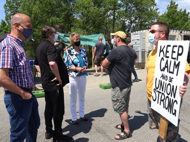 Sudbury MPP Jamie West, left, former United Steelworkers international president Leo Gerard and Nickel Belt MPP France Gelinas talk with striking United Steelworkers Local 6500 members at a picket line in Copper Cliff, Ont. on Friday June 4, 2021. John Lappa/Sudbury Star/Postmedia Network