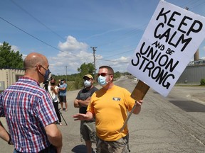 Sudbury MPP Jamie West, left, talks with striking United Steelworkers Local 6500 member Dave Johns at a picket line in Copper Cliff on June 4. West, Nickel Belt MPP France Gelinas and former United Steelworkers international president Leo Gerard visited striking workers to offer their support.