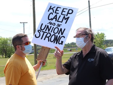 Former United Steelworkers international president Leo Gerard, right, talks with striking United Steelworkers Local 6500 member Dave Johns at a picket line in Copper Cliff, Ont. on Friday June 4, 2021. Gerard and local MPP's Jamie West and France Gelinas visited striking workers to offer their support. John Lappa/Sudbury Star/Postmedia Network