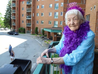 Lille Neemre celebrated her 100th birthday on Tuesday with a socially distanced celebration that included balloons, flowers, cake and neighbours and friends singing Happy Birthday outside while she watched from her balcony.