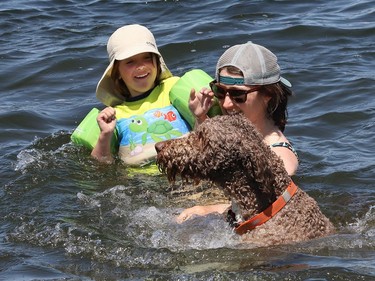 Jay (Jess) Ryan and her nephew, Oscar Ryan, 4, and Peat the dog play in the water at Ramsey Lake  on Wednesday.