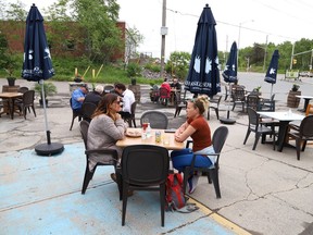 Lauren Oliver, left, and Lisa Labrecque have lunch on the patio at Di Gusto restaurant in Sudbury, Ont. on Friday June 11, 2021. Ontario moved into Step One of its reopening plan on Friday, three days ahead of schedule. Step One includes allowing non-essential retail stores to reopen, and bars and restaurants to begin serving customers on their patios. John Lappa/Sudbury Star/Postmedia Network