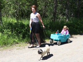 Leah Landriault goes for a walk on a trail at Fielding Memorial Park in Greater Sudbury, Ont. with her daughter, Olivia, 4, and her dog, Gizmo, on Wednesday June 16, 2021. John Lappa/Sudbury Star/Postmedia Network