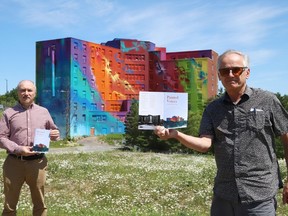 Tom Leduc, left, and Bernie Hughes, of the Sudbury Writers' Guild, display copies of Painted Voices. The chat book features poems and short stories about the General Hospital and the mural painted on the former hospital. John Lappa/Sudbury Star/Postmedia Network