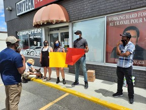 Migrant rights advocates gather Sunday outside the office of Nickel Belt MP Marc Serre to demand full and permanent immigration status for all newcomers. Supplied