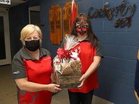 Jennifer Huard, right, president of Branch 564 of the Royal Canadian Legion, and event organizer and Branch 564 treasurer Doreen Thompson display some of the gift baskets that will be handed out to some lucky customers at the legion's Canada Day picnic meal takeout event in Sudbury, Ont. on July 1, 2021. The meal is $17 and includes two pieces of fried chicken, french fries, macaroni salad and dessert. The legion is asking the community to preorder on June 29-30 from noon to 3 p.m., by calling 705-522-6060.  John Lappa/Sudbury Star/Postmedia Network
