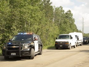 A fleet of OPP vehicles was parked along Kukagami Lake Road Monday afternoon after a vehicle was found on a nearby trail, with human remains inside.