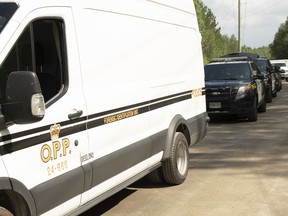 The OPP forensic identification unit, along with several SUVs, an OPP pickup and the fire investigator were on the scene Monday along Kukagami Lake Road. A vehicle was found on a trail off the roadway with human remains inside.