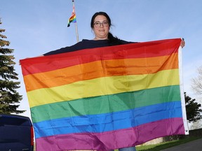 Michelle Levis, a teacher at Ecole secondaire Macdonald-Cartier in Sudbury, Ont., holds an LGBTQ flag outside the school on Wednesday June 6, 2018. Rev. Thomas P. Arth writes that accepting LGBTQ2SIA+ into the church makes us complete. John Lappa/Sudbury Star/Postmedia Network