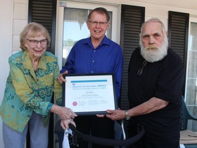 Paul Marley (centre) is flanked by his wife Lois Marley and Plympton-Wyoming Mayor Lonny Napper while receiving an Ontario Senior of the Year Award. Marley, a retired pharmacist, was nominated by the municipality. Paul Morden/Postmedia Network