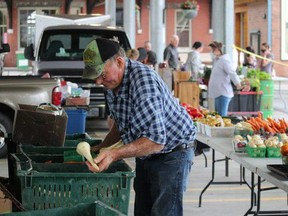 Art Vrolyk prepares produce at the Petrolia Farmers' Market in this file photo from 2020. Petrolia is introducing a new weekly Tuesday Night Market that will run at the same location from July 6 to Aug. 31. File photo/Postmedia Network