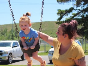 Lyndsay Raymond was spending the mild sunny afternoon on Friday with her daughter Sloane Letourneau, 3, who was having fun on the swings in the playground at Hollinger Park. The nice weather is expected to continue Saturday with mainly sunny conditions.

RICHA BHOSALE/The Daily Press