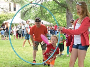 Lily Verberne holds the hula hoop steady for Michael Brown during an Annandale National Historic Site Canada Day Fun Fair. Nearly 1,000 people attended on July 1, 2015. This year the museum is planning 'Canada Day in the Bag' for the people to create their own Fun Fairs at home. (Chris Abbott/File Photo)