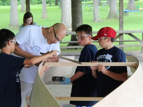 David Vine, founder of Stem2Stern, works with a group of children building a 12-foot skiff. Vine will be leading a boat-building project in Tillsonburg starting June 28 at the Upper Deck Youth Centre. (Submitted)