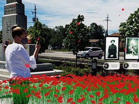 Lauren Donker, Elgin County Museum summer student, tests St. Thomas Remembers, the museum's new augmented reality adventure at the Veterans Memorial Garden, in which local veterans tell their stories.Elgin County Museum