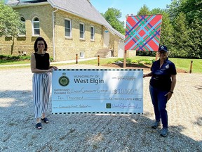 Shelly Vergeer, treasurer of the Eagle Community Centre, left, was presented a $10,000 cheque by West Elgin Coun. Bonnie Rowe, right. The funds will help with a major foundation repair for the centre. (Handout/Postmedia Network)