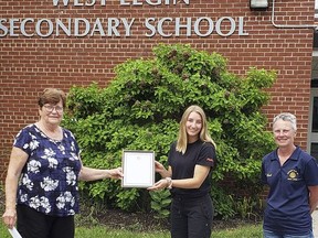 Paige Doherty, centre, is this year's winner of the West Lorne Optimist Club essay contest. Presenting the $200 cheque and certificate are club president Joan Neil, left, and essay contest chair Barb Ross, right.