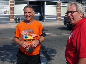 Rick Fall, left, laughs as he chats with Kenora Mayor Dan Reynard on Monday, June 29. Fall stopped in Kenora on his way to Sault Ste Marie. The 62-year-old's run, which began in Victoria, is meant to raise money for cancer research.