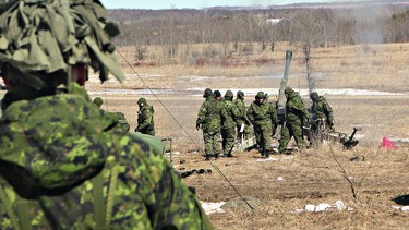 Lt. Col. Robert Christopher (back to camera), a commanding officer of the 56th Field Artillery, watches as a howitzer fires off a round during a training exercise at the 4th Canadian Division Training Centre  Meaford in 2018. File photo