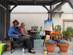 Artists Tony Miller and Lorraine Thomson took shelter from the rain and painted on the shed deck next to Grey Gallery in the Grey Garden of 2nd Avenue East in downtown Owen Sound Saturday as part of the ArtWalk event and Urban Sketchers' competition. Greg Cowan/The Sun Times