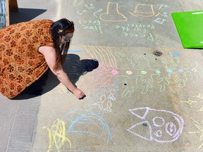 Local artist Jennifer Hicks works on a chalk art mural on the sidewalk in front of the Grey Gallery on 2nd Avenue East in Owen Sound in 2019. Denis Langlois/The Owen Sound Sun Times/File photo