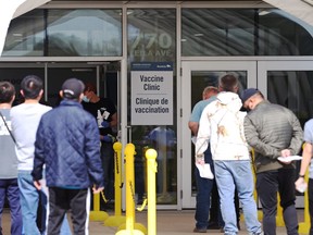 People queue outside the COVID-19 vaccination site on Leila Avenue in Winnipeg on Wednesday, May 12, 2021.